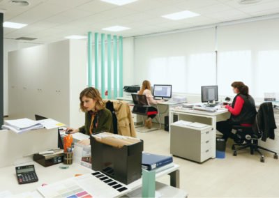Foto panorámica de las oficinas de MBY. Muestra tres personas trabajando con ordenador.